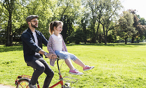 quality-of-life-young-man-with-child-on-bicycle